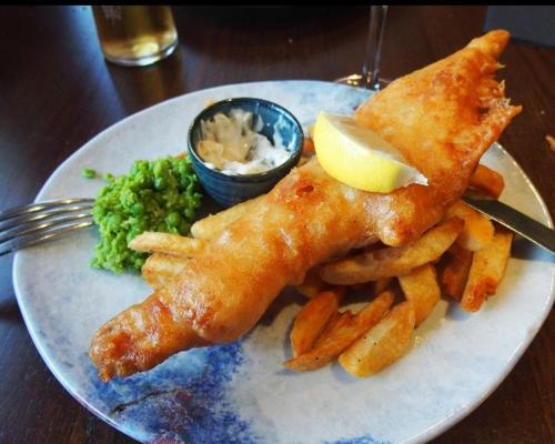 a plate of food with fish and french fries at The Boyne Arms in Burwarton