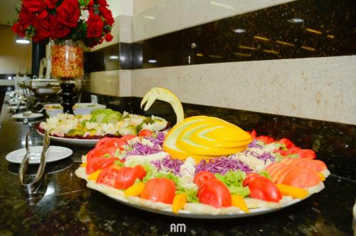 a plate of food with a swan on a table at Hotel São Bento in Marabá