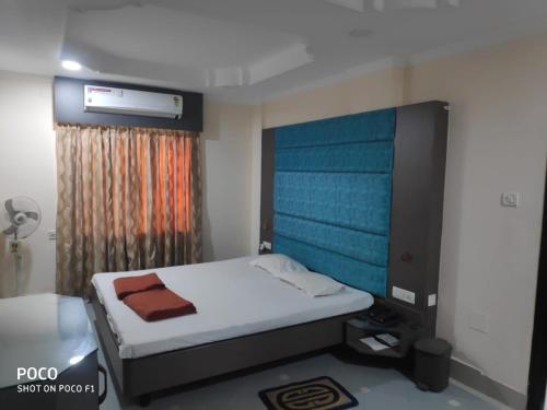 a small bedroom with a bed and a window at Saraswati Retreat in Bhubaneshwar