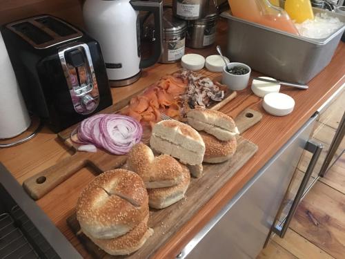 a cutting board with sandwiches and onions on a counter at The Waterford Inn in Provincetown