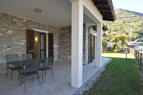 a patio of a house with a table and chairs at Villa Carolina in Domaso