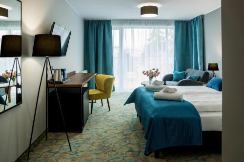 En eller flere senge i et værelse på STELLA Resort & SPA