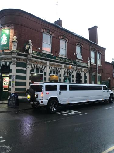 a white limo parked in front of a building at Shanahans B&B with Sports Bar in Birmingham