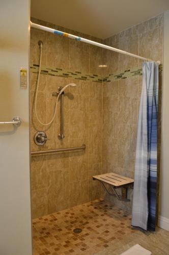 a bathroom with a shower with a shower curtain at El Rey Inn in Gardena