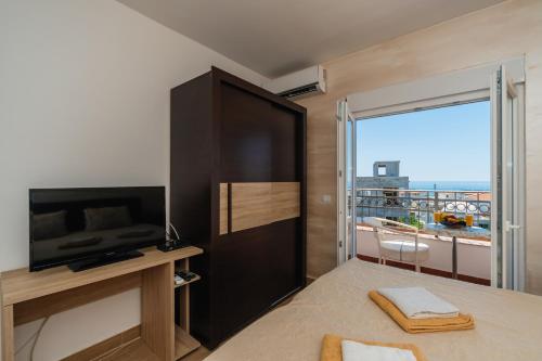 A television and/or entertainment centre at ApartHotel Stijovic