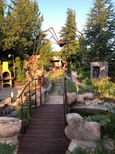 a wooden bridge over a pond in a park at Cabañas De Madera Y Bungalows - Gilmañas 3 in La Iruela