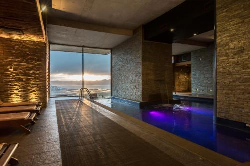 a bathroom with a swimming pool with a view of the ocean at Enjoy Chiloé in Castro