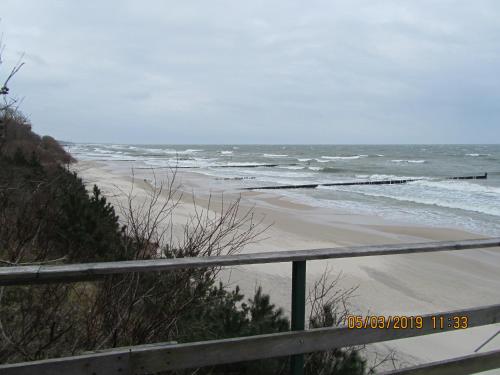 a beach with a fence and the ocean at Altstadt Ferienwohnung in Wismar