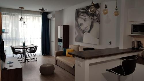 a living room with a couch and a table at Adams Apartment Onix Blue in Mamaia Nord