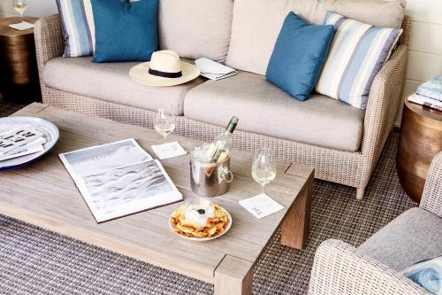 a coffee table in a living room with a couch at The Stanford Park Hotel in Menlo Park