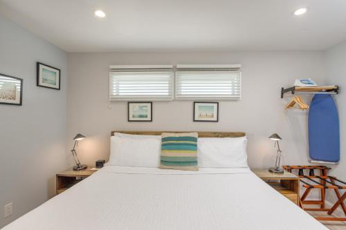 a bedroom with a large bed with white sheets at Aqualina Inn Montauk in Montauk