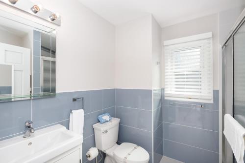 a bathroom with a toilet and a sink at Aqualina Inn Montauk in Montauk