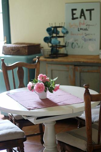 a table with a vase of flowers on top of it at Pfarrhof Stuer in Stuer