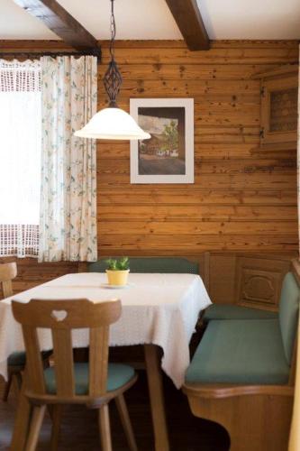 a dining room with a table and two chairs at Birkenhof in Sankt Veit in Defereggen