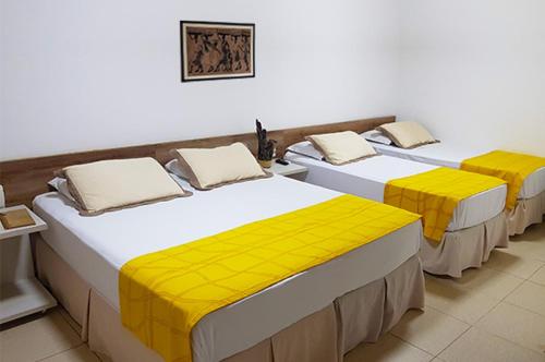 A bed or beds in a room at Pousada Aconchego