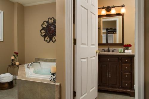 a bathroom with a tub and a sink at 1825 Inn Bed and Breakfast in Palmyra