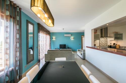 a living room with a ping pong table in the middle at Mar da Luz Terrace Apt 118 in Lagos