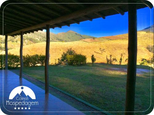 a view from the porch of a house with a mountain at Hospedagem Colinas in Aiuruoca