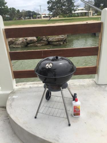 a charcoal grill sitting on top of a table at Royale Manor in Corozal