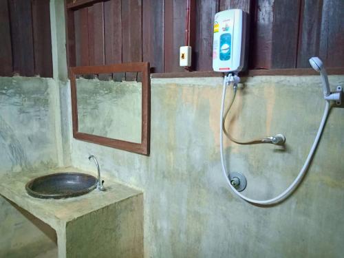 a bathroom with a shower and a sink at Namkhong Guesthouse and Resort in Chiang Khong