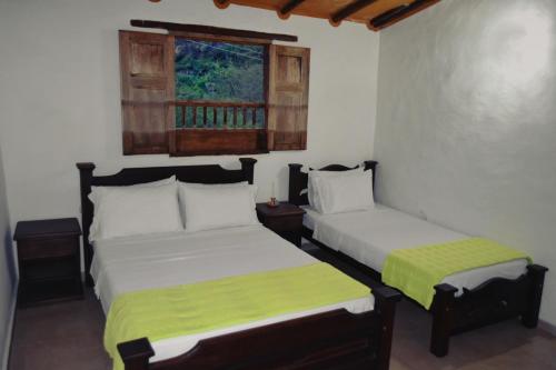 En eller flere senger på et rom på Posada Villa Paula