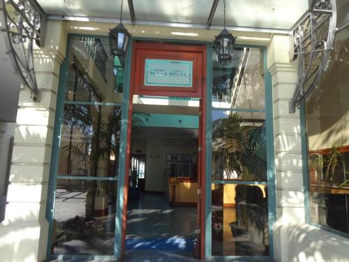 an entrance to a building with a red door at Hotel Plaza Rafaela in Rafaela