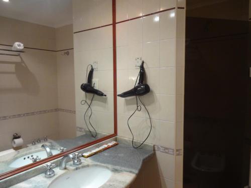 a bathroom with a phone on the wall next to a sink at Hotel Plaza Rafaela in Rafaela