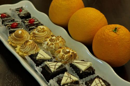 a plate of chocolate desserts and oranges on a table at Hanan Hotel Tagaytay - Formerly Tagaytay Wingate Manor in Tagaytay