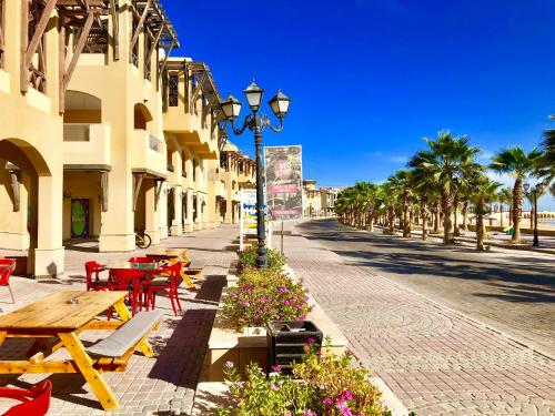 a street with tables and chairs and a street light at Luxury Villa with pool in Hurghada in Hurghada