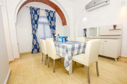a dining room with a table and chairs at Luxury Villa with pool in Hurghada in Hurghada