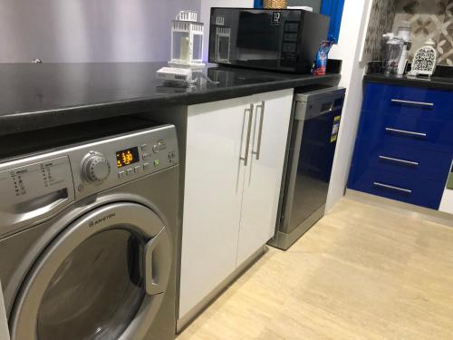 a kitchen with a washing machine and a microwave at Luxury Villa with pool in Hurghada in Hurghada