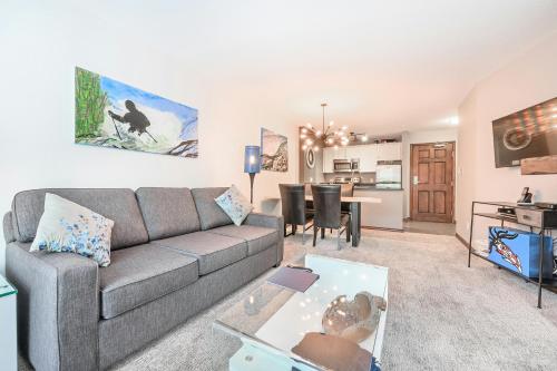 a living room with a couch and a table at The Best ski-in/ski-out at The Aspens in Whistler