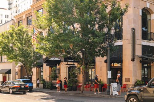 people walking on a street in front of a building at Dossier in Portland