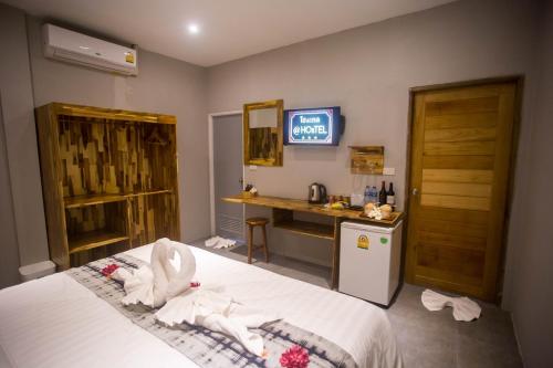 a hotel room with a bed with towels on it at @HOsTEL PHANGAN in Baan Tai