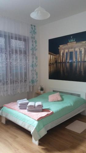 Ferienwohnung 3 في برلين: غرفة نوم بسرير مع لوحة على الحائط
