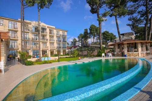 een groot zwembad voor een gebouw bij Black Sea Riviera Hotel in Shekhvetili