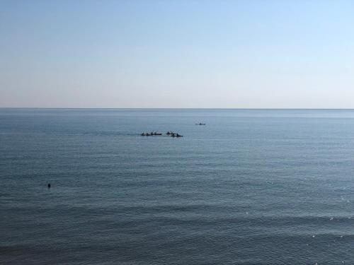 a large body of water with a group of people in it at Paradiso fronte Mare in Agnone Bagni