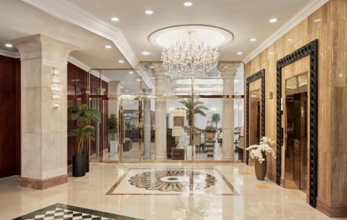 a lobby with a chandelier in a building at GoldOne Hotel & Suites in Seogwipo