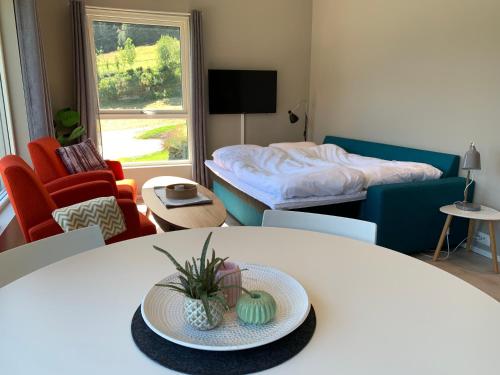 a living room with a table and a bed at Olden Fjord Apartments in Olden