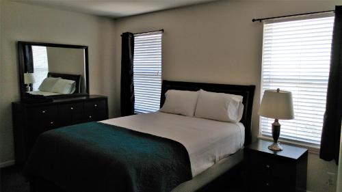 a bedroom with a bed and a large mirror at Campbell's Accommodations in Gull Lake