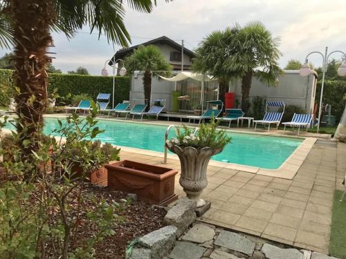 a swimming pool with a planter next to a house at B&B Villa Botto in Cossato