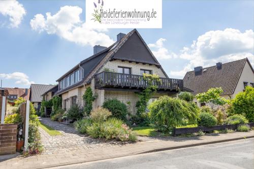 a house with a balcony on the side of a street at heideferienwohnung in Walsrode