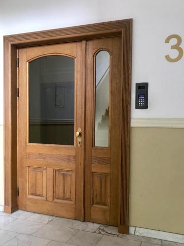 a wooden door with a window on a building at VULTOR Apartments in Wrocław