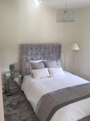a bedroom with a large bed with a silver headboard at Fascinating & Luxurious Golf,Mountain & Garden view apartment Porto Banus in Marbella
