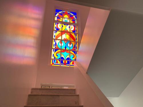 a stained glass window in a church with stairs at Kobuleti VILLA SKAZOCNI DVORIK VIP in K'obulet'i
