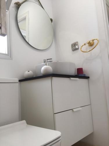 a white bathroom with a mirror and a sink at Fascinating & Luxurious Golf,Mountain & Garden view apartment Porto Banus in Marbella