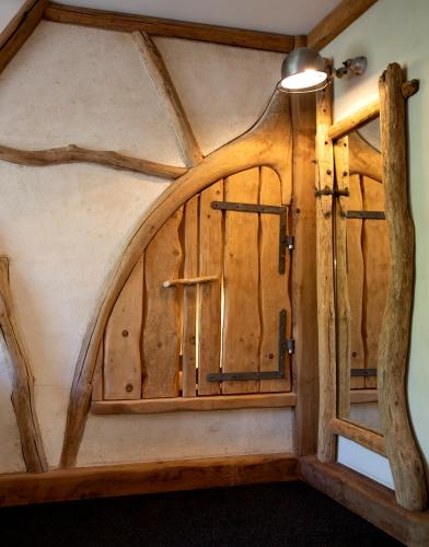 a room with a wooden door and a ceiling at Hotel du Golf in Corrençon-en-Vercors