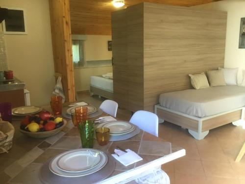 a room with a bed and a table with plates on it at SUNNY STUDIO in Skala Marion