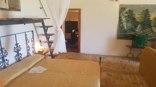 a bedroom with a bed and a painting on the wall at Case Brizza in Casale Zappulla