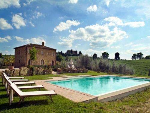 a large swimming pool in front of a building at Villa Gaeta in Montefollonico
